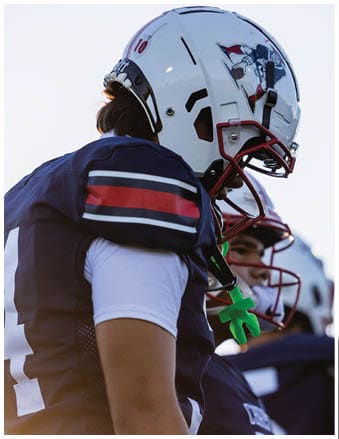 A football player running on the field. Description generated by AI