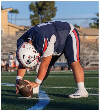 A football player running on the field. Description generated by AI