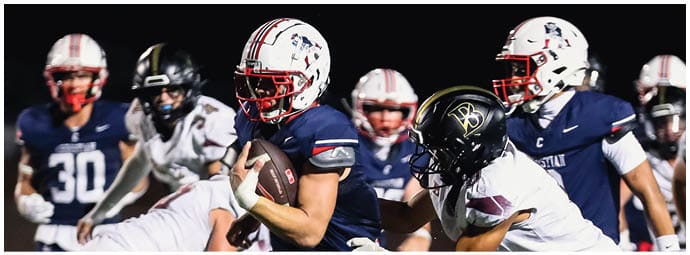 A football player is sliding on the ground. Description generated by AI