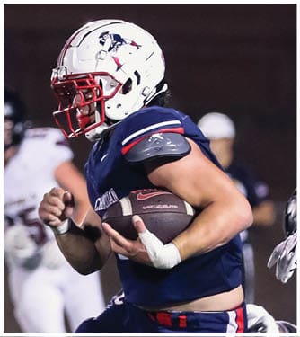 A football player running on the field. Description generated by AI