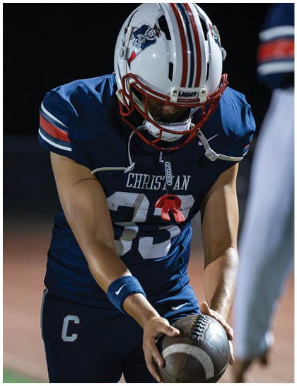 A football player wearing a blue jersey with the number 58 on it. Description generated by AI