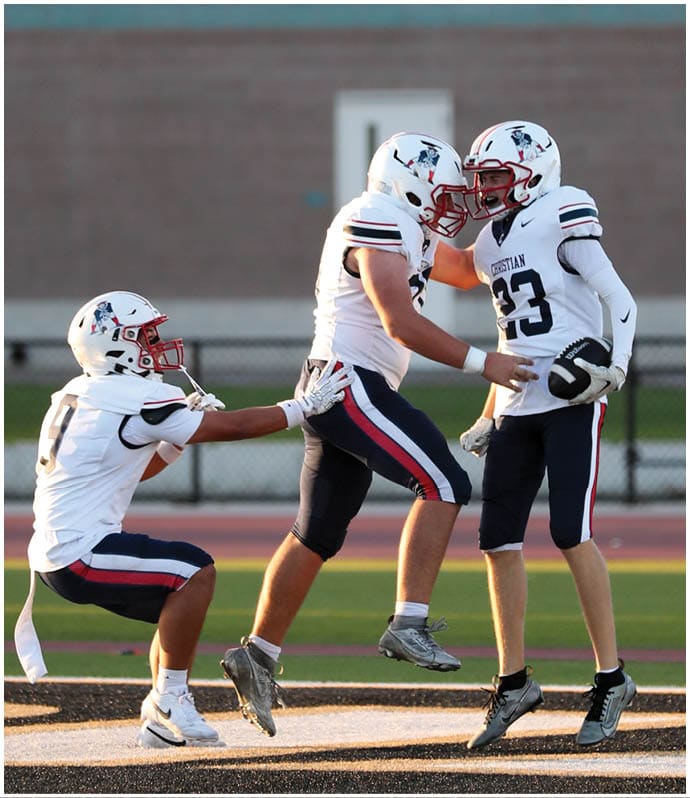 A group of football players wearing black and white uniforms. Description generated by AI
