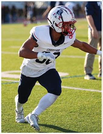 A football player running on the field. Description generated by AI