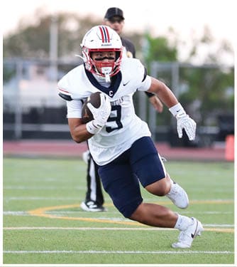 A football player running on the field. Description generated by AI