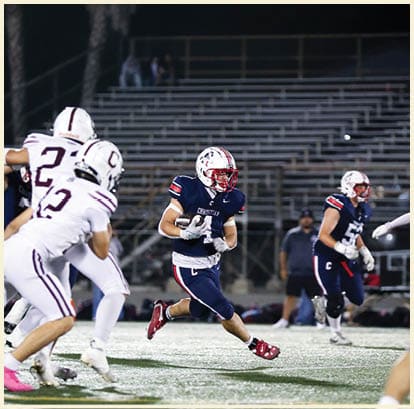 A football player is kicking a football on a field. Description generated by AI