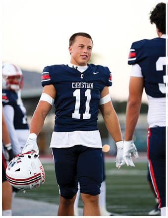 A football player running on the field. Description generated by AI