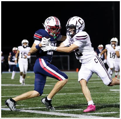 A football player is kicking a football on a field. Description generated by AI