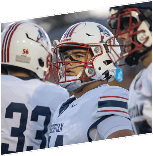 Three men wearing green and white uniforms are standing on a field. Description generated by AI