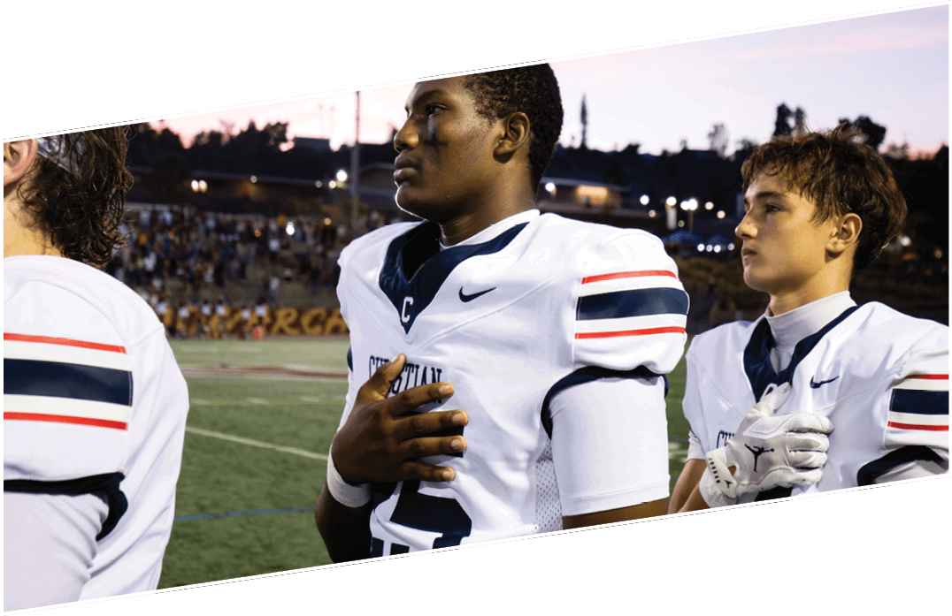 Three men wearing green and white uniforms are standing on a field. Description generated by AI