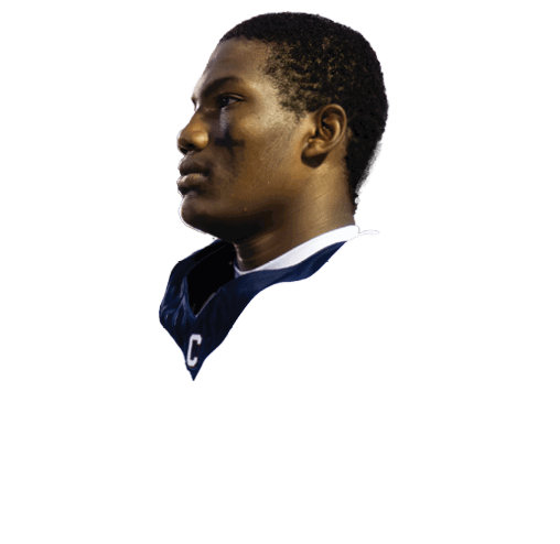A person wearing a white sports jersey with a Nike logo is looking to the side against a plain background. Description generated by AI
