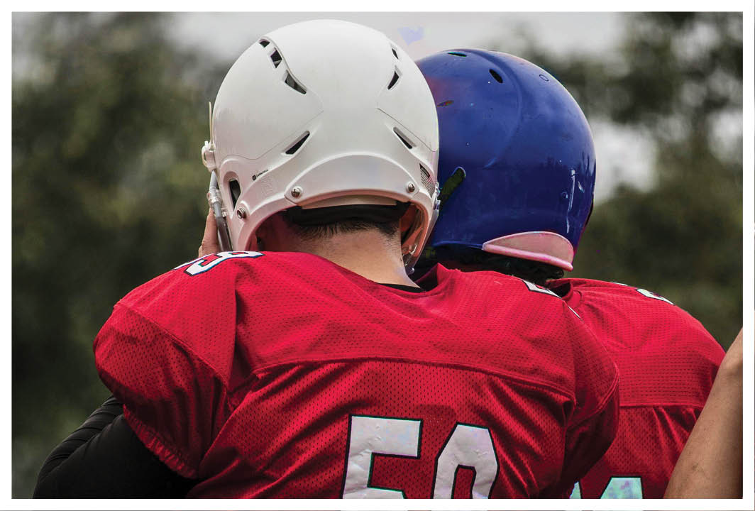 A man wearing a red and white jersey with the number 53 on it. Description generated by AI