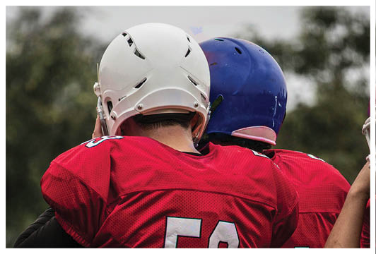 A man wearing a red and white jersey with the number 53 on it. Description generated by AI