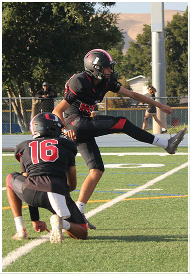A football player wearing a blue and red jersey. Description generated by AI