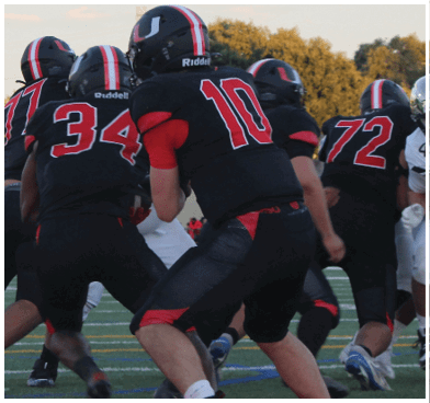 A football player wearing a blue and red jersey. Description generated by AI