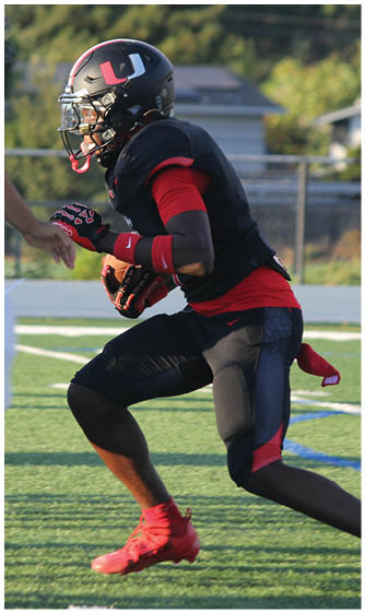A football player running on the field. Description generated by AI