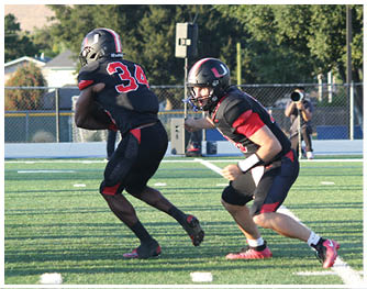 A football player running on the field. Description generated by AI