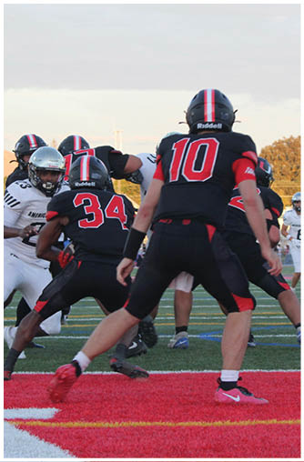 A football player running on the field. Description generated by AI