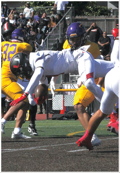 A football player wearing a blue and red jersey. Description generated by AI
