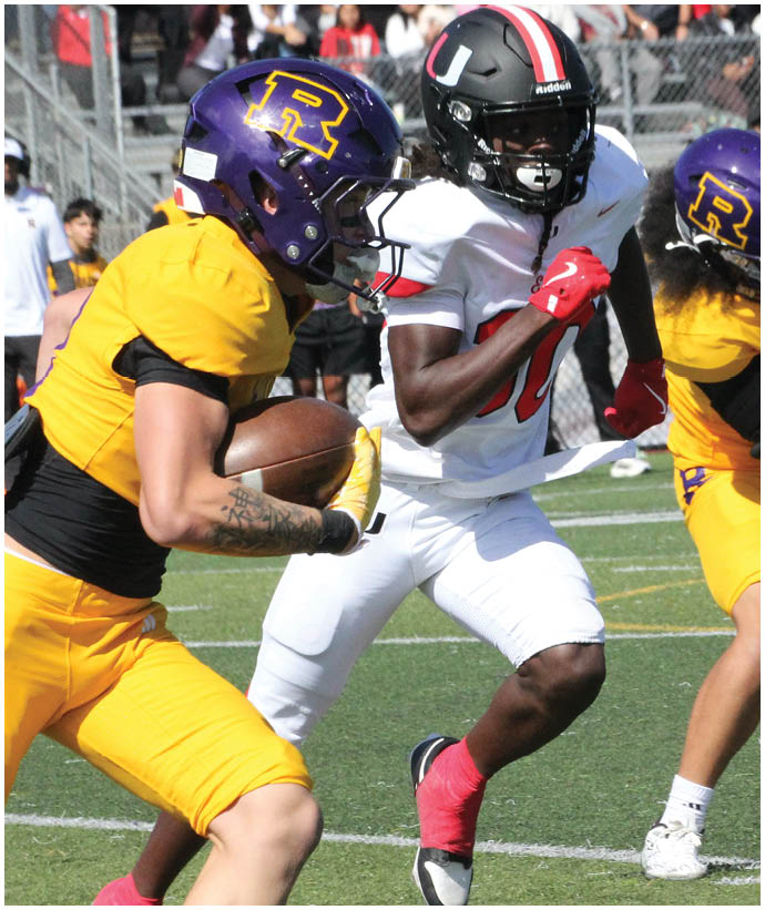 A group of football players wearing black and white uniforms. Description generated by AI