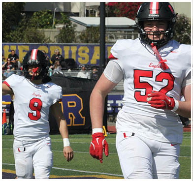 A football player wearing a blue and red jersey. Description generated by AI