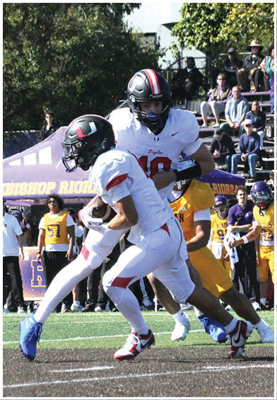 A football player wearing a blue and red jersey. Description generated by AI