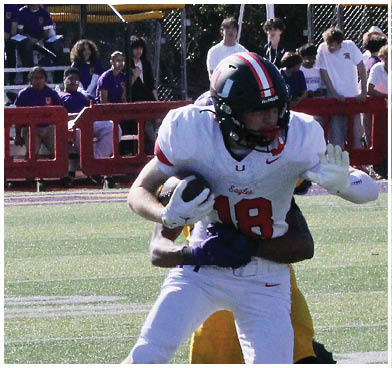 A football player wearing a blue and red jersey. Description generated by AI