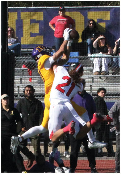 A football player wearing a blue and red jersey. Description generated by AI