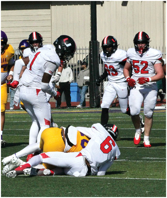 A group of football players wearing black and white uniforms. Description generated by AI