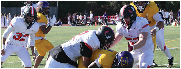 A football player is sliding on the ground. Description generated by AI