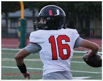 A football player running on the field. Description generated by AI