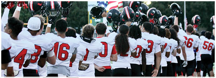 A group of football players on a field. Description generated by AI