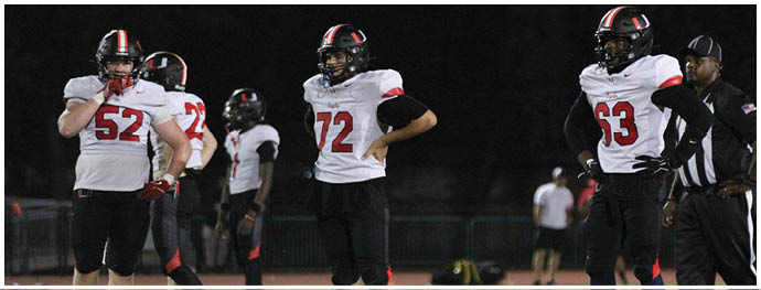 A football player is sliding on the ground. Description generated by AI