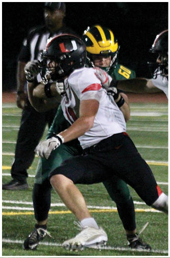 A football player running on the field. Description generated by AI