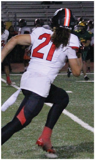 A football player running on the field. Description generated by AI
