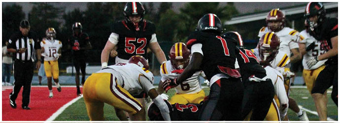 A group of football players on a field. Description generated by AI