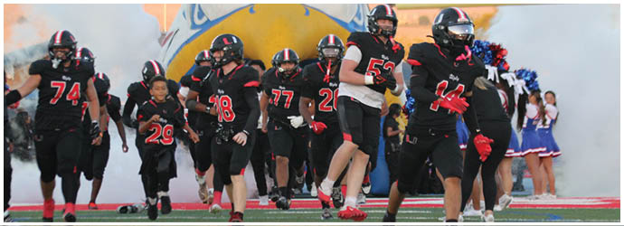 A group of football players on a field. Description generated by AI