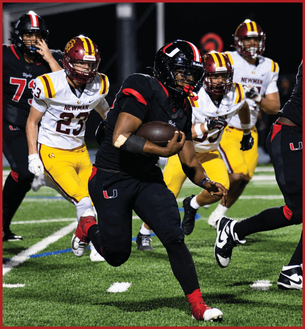 A football player running on the field. Description generated by AI