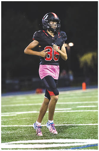 A football player running on the field. Description generated by AI