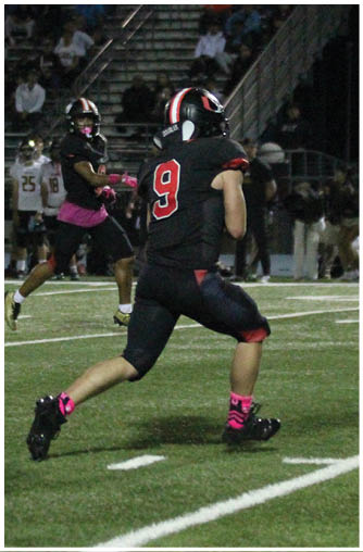 A football player running on the field. Description generated by AI