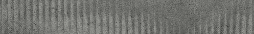 A close-up view of a textured surface with vertical ridges and a rough, grayish pattern. Descripci n generada con IA