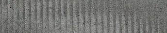 A close-up view of a textured surface with vertical ridges and a rough, grayish pattern. Descripci n generada con IA
