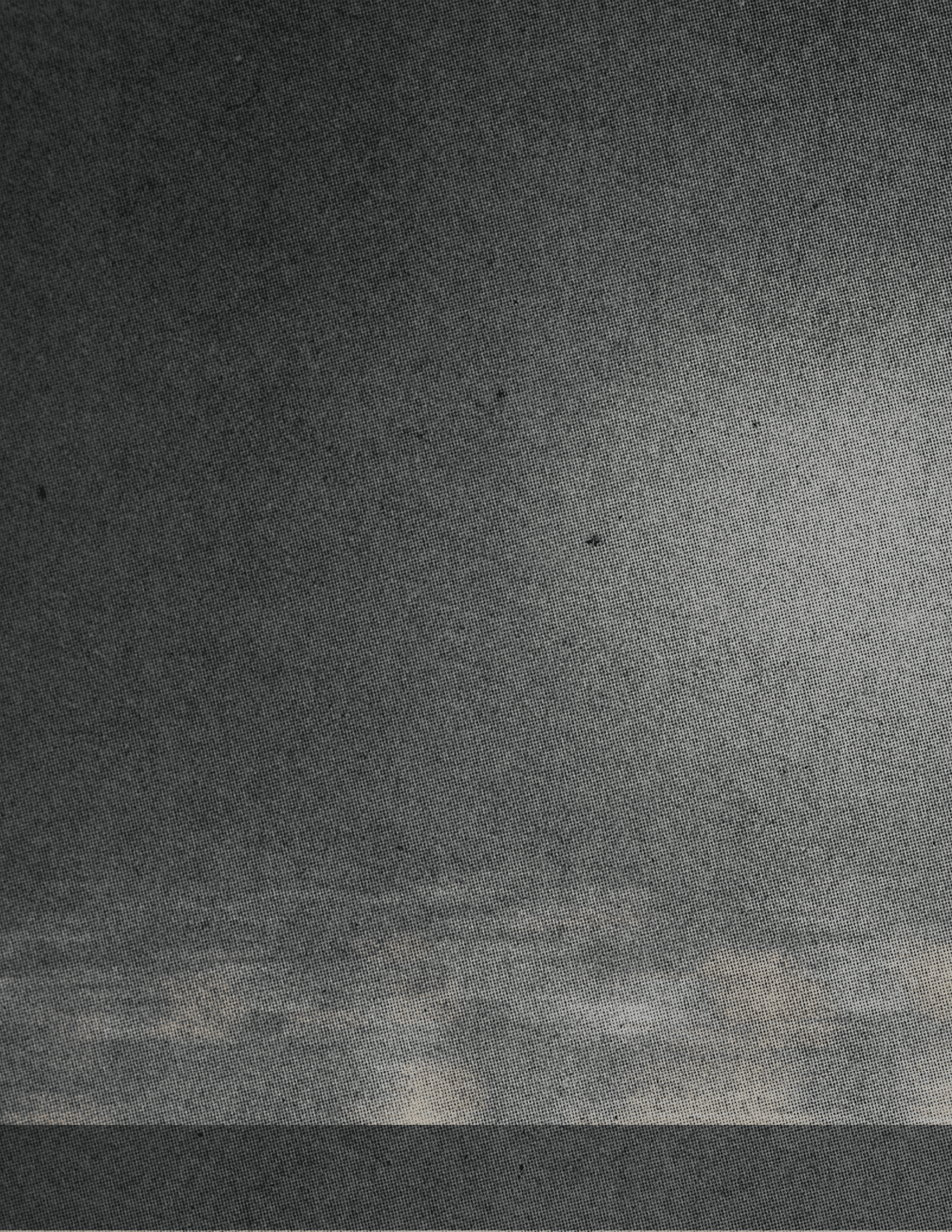 A dark textured surface with a faint, blurry horizontal band of muted colors near the bottom. Descripci n generada con IA