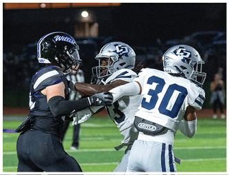 Two people in football uniforms are engaged in a play on a field, with one holding the ball and the other attempting to block or tackle. Descripci n generada con IA