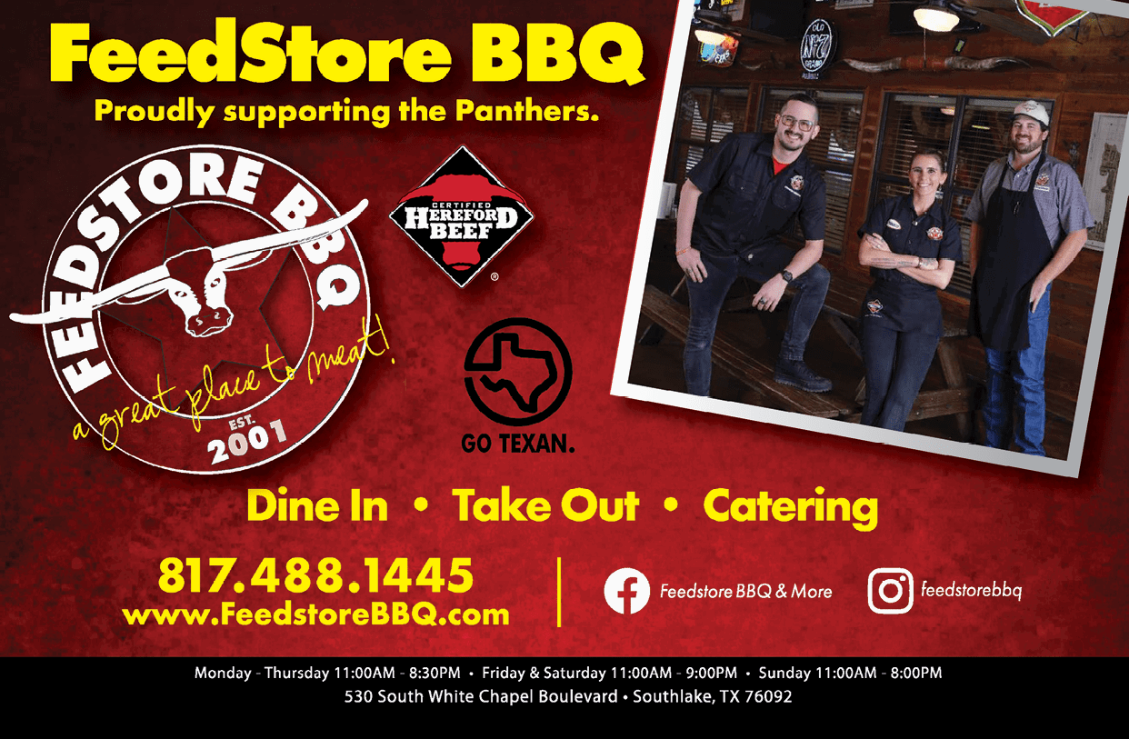 Three adults wearing casual work attire pose inside a rustic barbecue restaurant alongside a red and yellow advertisement for FeedStore BBQ promoting dine-in, takeout, and catering services with contact information and location details. Description generated by AI