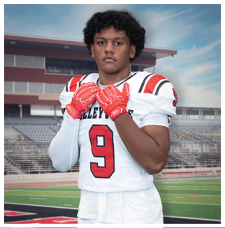 A football player wearing a blue and red jersey. Description generated by AI