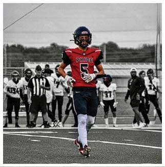 A football player wearing a blue and red jersey. Description generated by AI