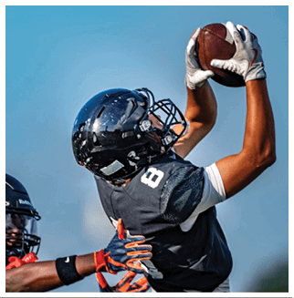 A football player wearing a blue and red jersey. Description generated by AI
