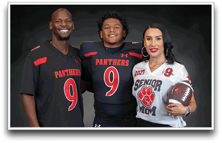Three adults wearing sports jerseys with the number nine, one holding a football and wearing a “Senior Mom" jersey. Description generated by AI