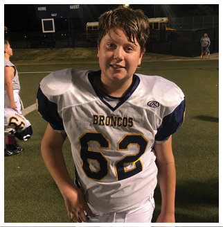 A football player wearing a blue and red jersey. Description generated by AI