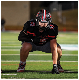 A football player wearing a blue and red jersey. Description generated by AI